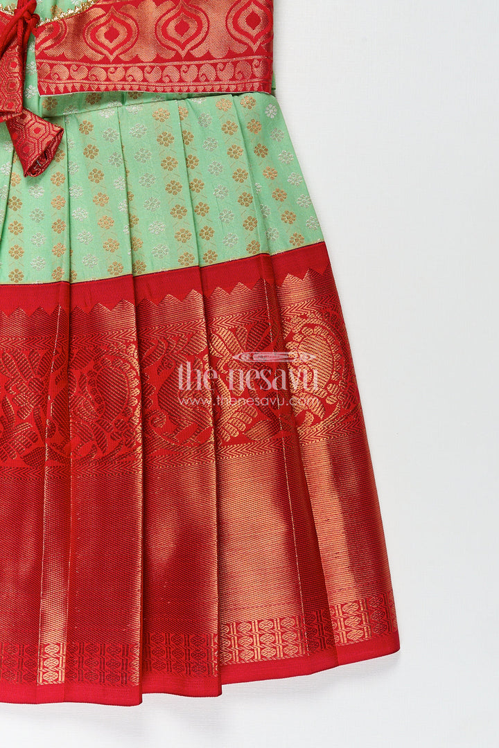 The Nesavu Girls Kanchi Silk Frock Girls Kanchivaram Pattu Saree Long Frock with Puff Sleeves in Green and Red Zari Woven Traditional Style Nesavu Nesavu Girls Pattu Saree Long Frock Kanchivaram Silk Green Body Red Zari Pleated Border