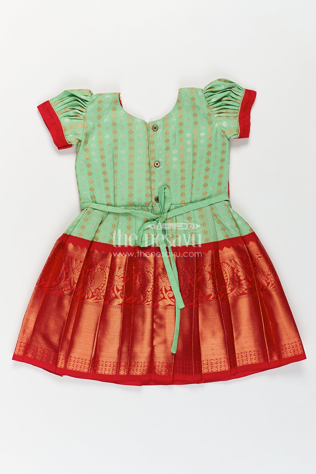 The Nesavu Girls Kanchi Silk Frock Girls Kanchivaram Pattu Saree Long Frock with Puff Sleeves in Green and Red Zari Woven Traditional Style Nesavu Nesavu Girls Pattu Saree Long Frock Kanchivaram Silk Green Body Red Zari Pleated Border