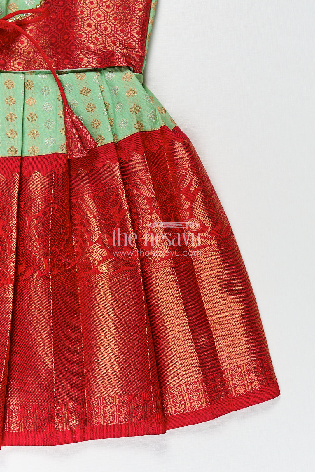 The Nesavu Girls Kanchi Silk Frock Girls Kanchivaram Pattu Saree Long Frock with Puff Sleeves in Green and Red Zari Woven Traditional Style Nesavu Nesavu Girls Pattu Saree Long Frock Kanchivaram Silk Green Body Red Zari Pleated Border