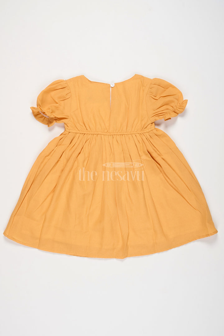 The Nesavu Girls Cotton Frock Girls Mustard Cotton Frock with Embroidered Yoke and Puff Sleeves in Simple Frock Design Cotton Look Nesavu Nesavu Girls Cotton Frock Mustard Embroidered Front Puff Sleeves frock design cotton