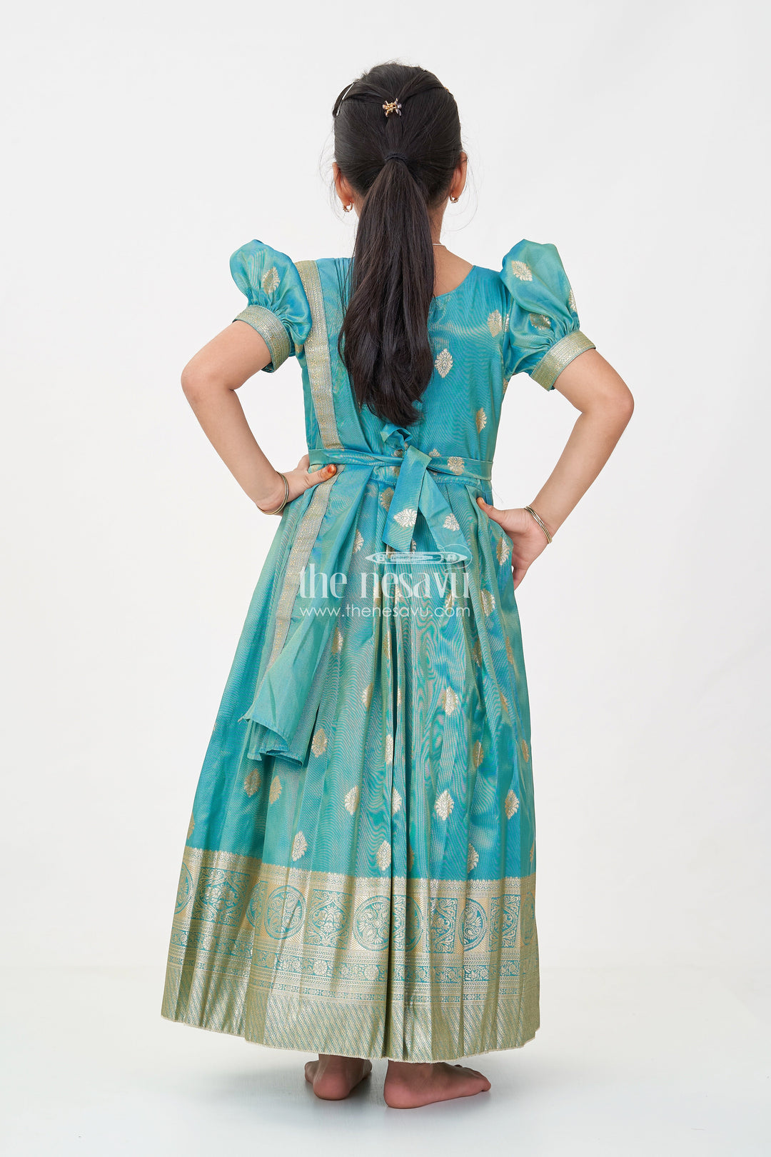 The Nesavu Girls Silk Gown Girls Pattu Gown in Banarasi Silk Blend Jacquard with Zari Big Border and Puff Sleeves for Festive Flair Nesavu Traditional Girls Pattu Gown in Banarasi Silk Blend Jacquard with Zari Border and Puff Sleeves | The Nesavu