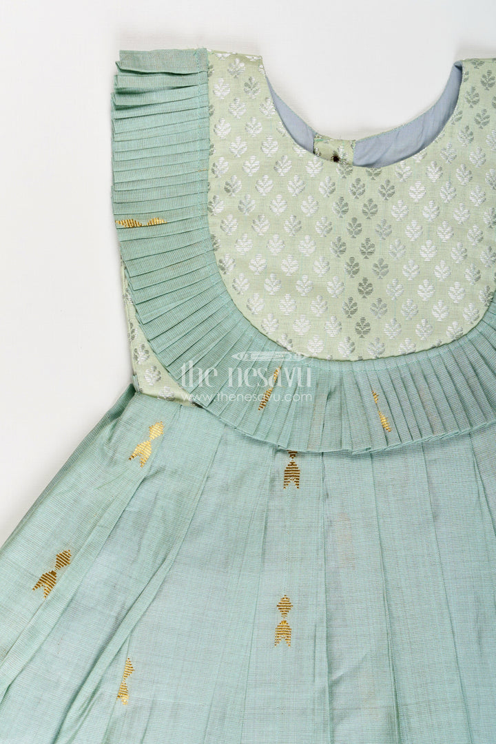 The Nesavu Silk Frock Girls Pattu Long Frocks Designs in Green Viscose with Semi Banaras Yoke and Pleated Details Nesavu Nesavu Pattu Long Frocks Designs Green Viscose Banaras Yoke Pleated Skirt