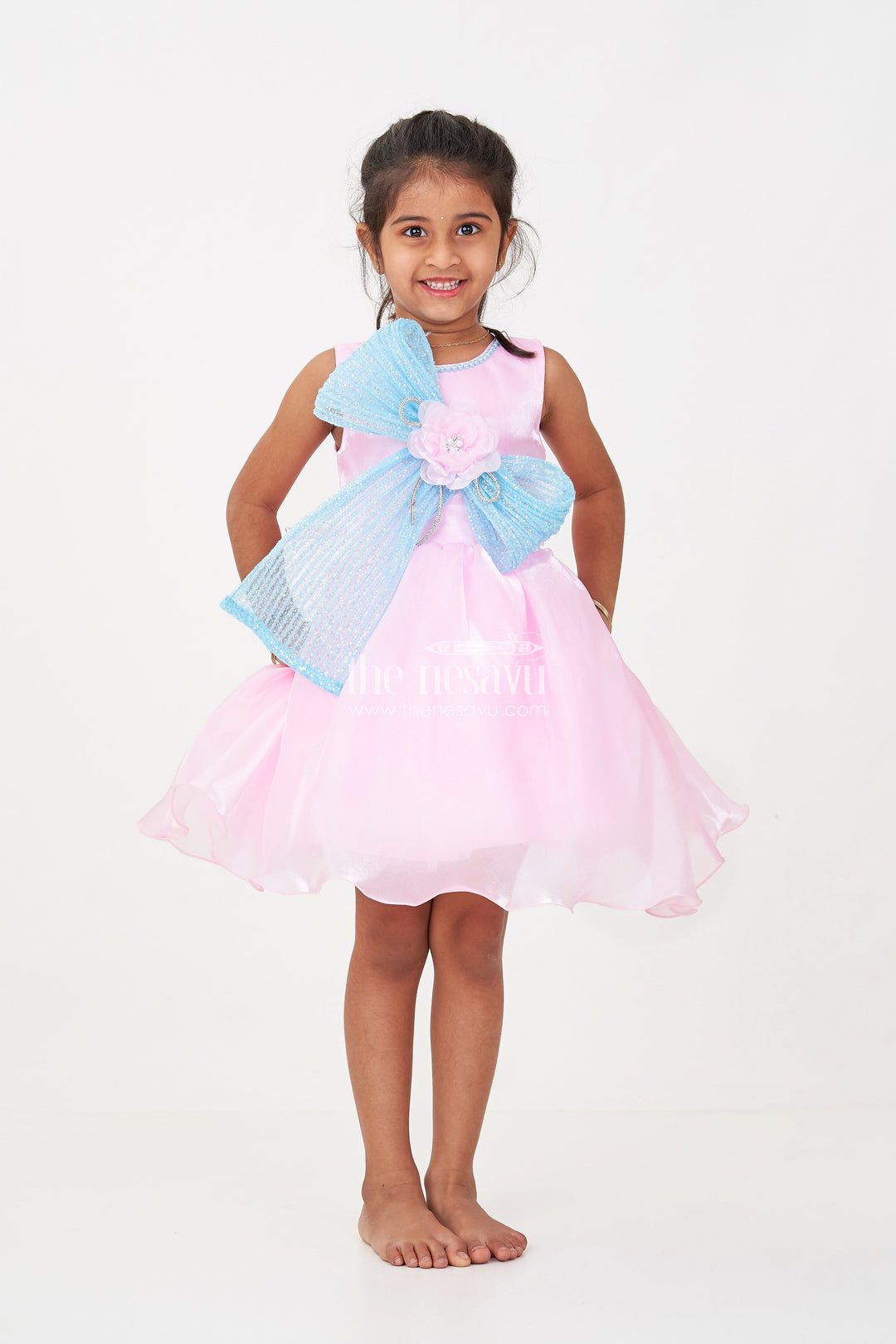 The Nesavu Girls Fancy Party Frock Girls Pink Net Frock with Blue Glitter Bow and Floral Accent in Glazed Organza Fabric Nesavu Girls Pink Net Frock Blue Glitter Bow Glazed Organza Party Wear | The Nesavu