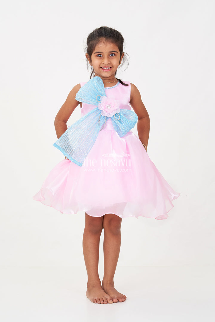 The Nesavu Girls Fancy Party Frock Girls Pink Net Frock with Blue Glitter Bow and Floral Accent in Glazed Organza Fabric Nesavu Girls Pink Net Frock Blue Glitter Bow Glazed Organza Party Wear | The Nesavu