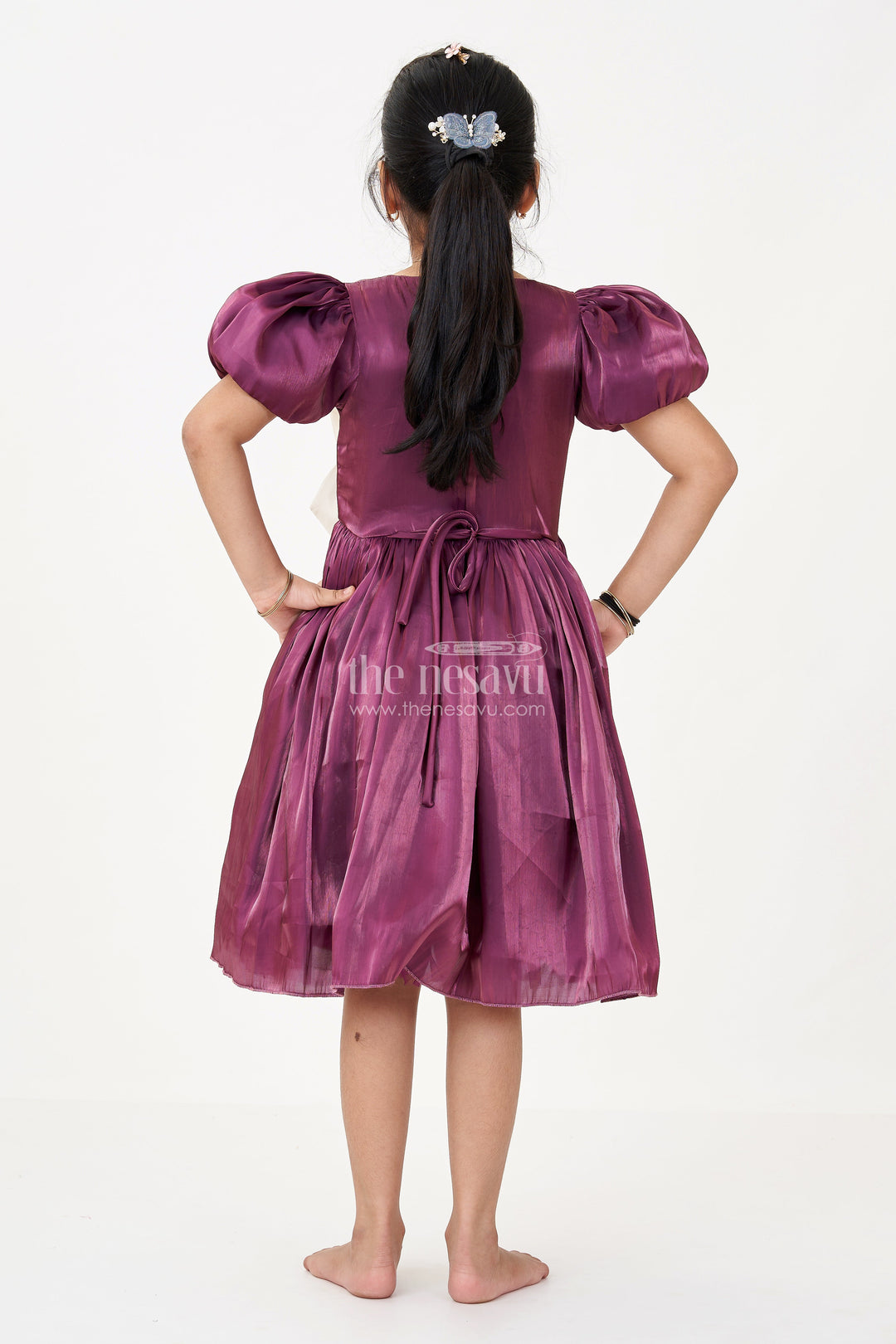 The Nesavu Girls Fancy Frock Girls Purple Frock Dress in Glossy Satin with Ivory Bow and Crown Brooch for Party Elegance Nesavu Girls Purple Frock Dress Satin Ivory Bow Crown Brooch Detail | The Nesavu