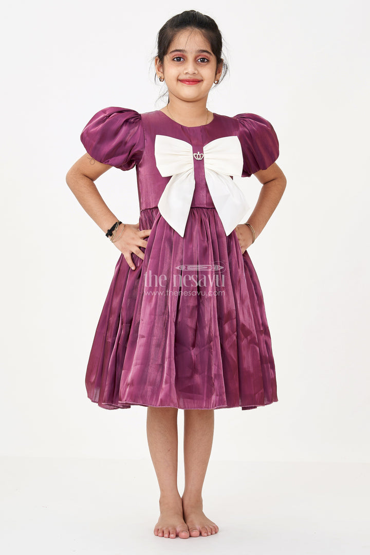 The Nesavu Girls Fancy Frock Girls Purple Frock Dress in Glossy Satin with Ivory Bow and Crown Brooch for Party Elegance Nesavu Girls Purple Frock Dress Satin Ivory Bow Crown Brooch Detail | The Nesavu
