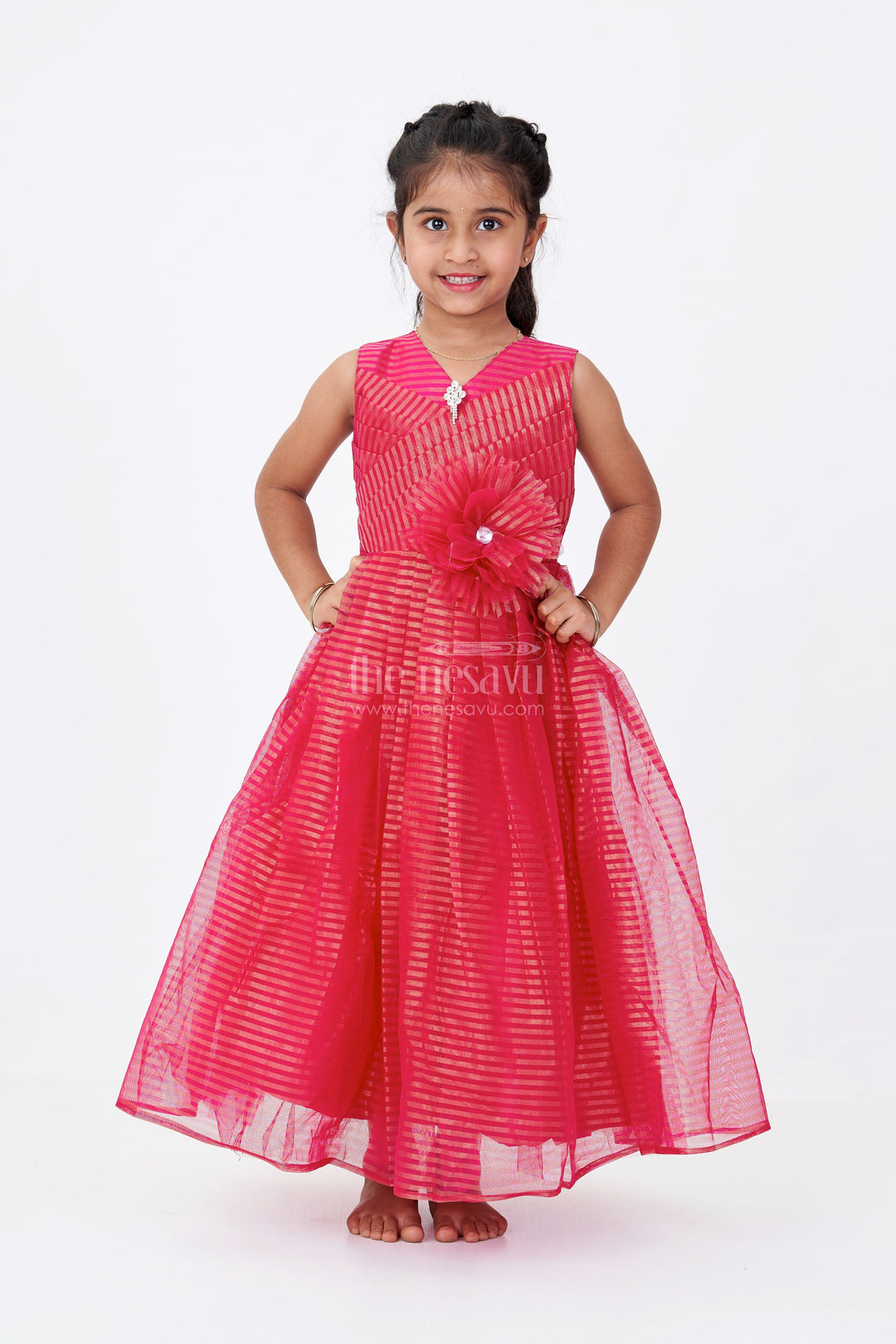 The Nesavu Girls Silk Gown Girls Red Silk Gown in Soft Net with Stripe Design and Oversized Floral Waist Embellishment Nesavu Girls Red Silk Gown Soft Net Gold Stripes Waist Flower Detail | The Nesavu