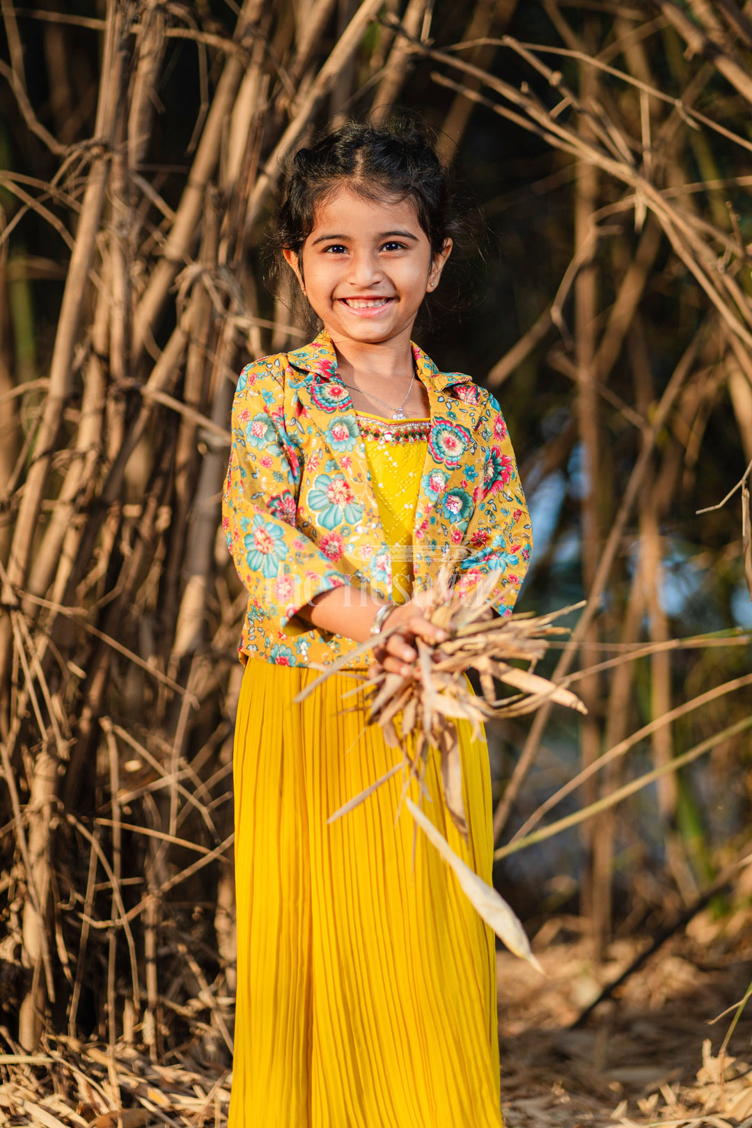 The Nesavu Girls Sharara / Plazo Set Girls Sharara Set in Vibrant Yellow with Floral-Printed Jacket and Palazzo Pants Nesavu Nesavu Girls Yellow Sharara Set Floral Jacket Pleated Palazzo Pants