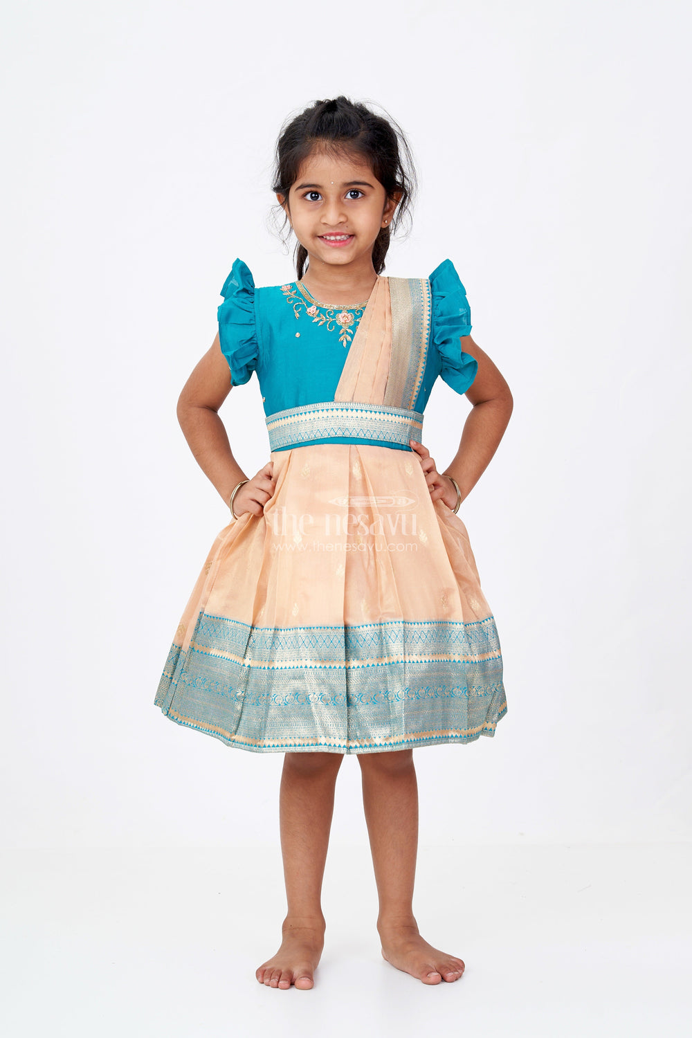 The Nesavu Silk Party Frock Girls Silk Saree to Frock with Traditional Zari Borders in Teal and Peach Nesavu Nesavu Girls Silk Saree to Frock Teal Peach Zari Border Design