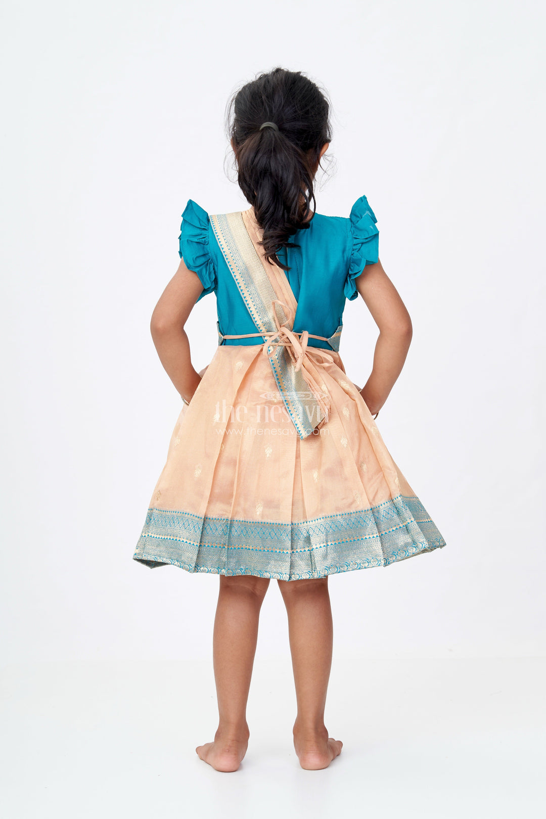 The Nesavu Silk Party Frock Girls Silk Saree to Frock with Traditional Zari Borders in Teal and Peach Nesavu Nesavu Girls Silk Saree to Frock Teal Peach Zari Border Design