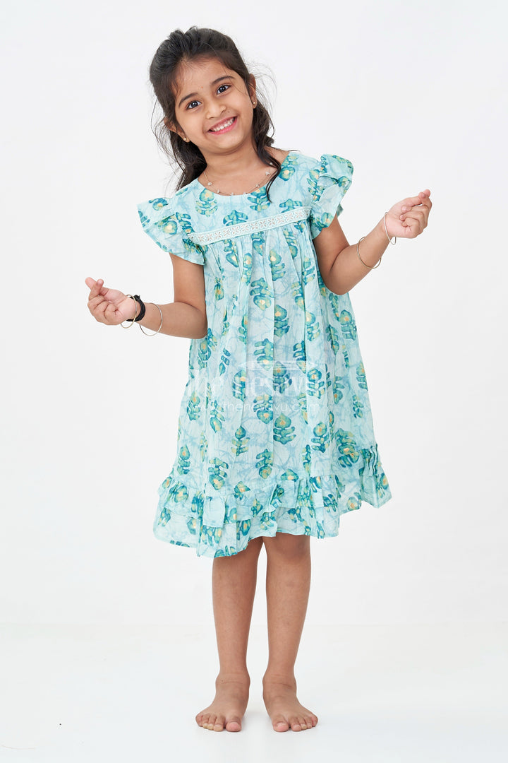 The Nesavu Girls Fancy Frock Girls Sky Blue Frock Design in Rayon with Leaf Motifs and Ruffle Accents for Whimsical Wear Nesavu 18 (2Y) / Blue GFC1761B-18 Nesavu Girls Sky Blue Frock Design Rayon Green Leaf Digital Print Ruffle Hem