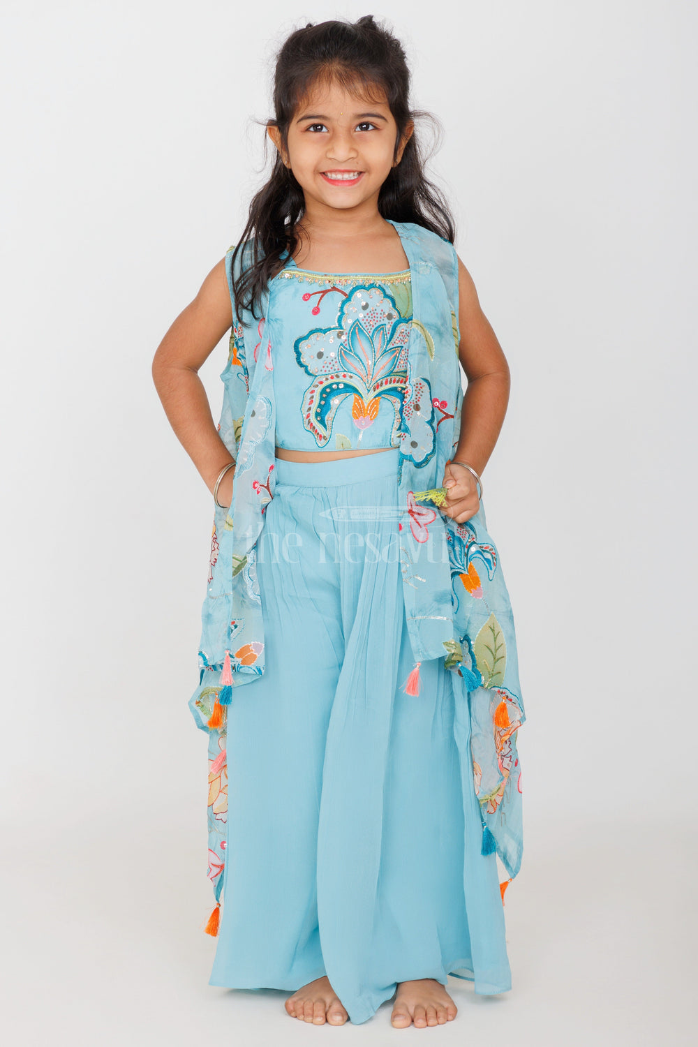 The Nesavu Girls Sharara / Plazo Set Girls Sky Blue Palazzo Set with Floral Embroidery and Tassel-Trimmed Sheer Jacket Nesavu Nesavu Girls Sky Blue Palazzo Set Floral Embroidered Crop Top Tassel Sheer Jacket