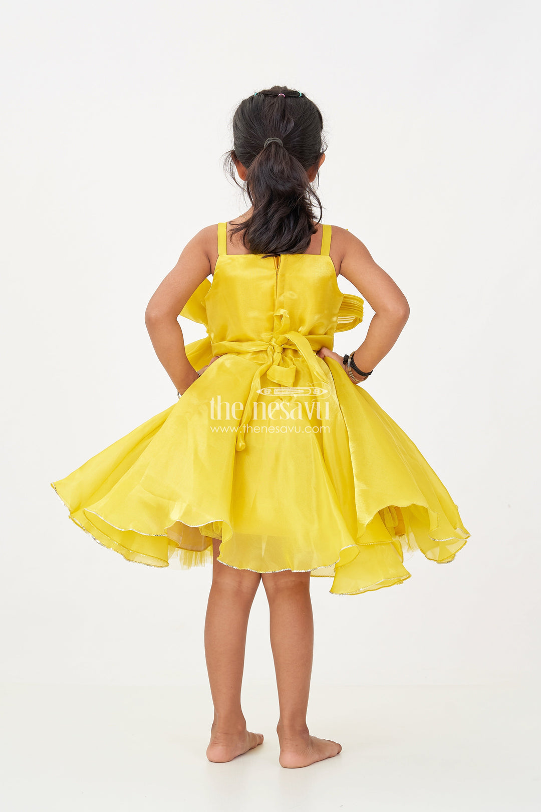 The Nesavu Girls Fancy Party Frock Girls Trendy Frock in Glossy Satin with Floral Waist Embellishment and Flowy Asymmetrical Hem Nesavu Girls Trendy Frock Glossy Satin Flowy Hem Floral Bow Embellishment | The Nesavu