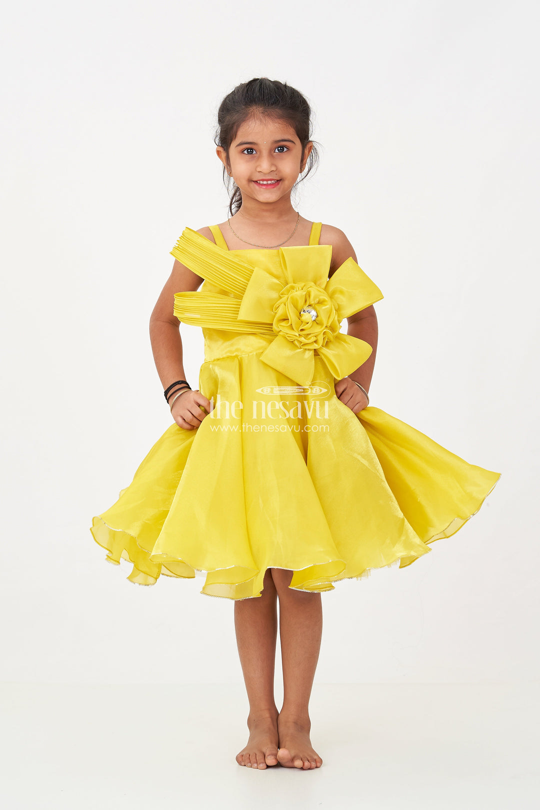 The Nesavu Girls Fancy Party Frock Girls Trendy Frock in Glossy Satin with Floral Waist Embellishment and Flowy Asymmetrical Hem Nesavu Girls Trendy Frock Glossy Satin Flowy Hem Floral Bow Embellishment | The Nesavu