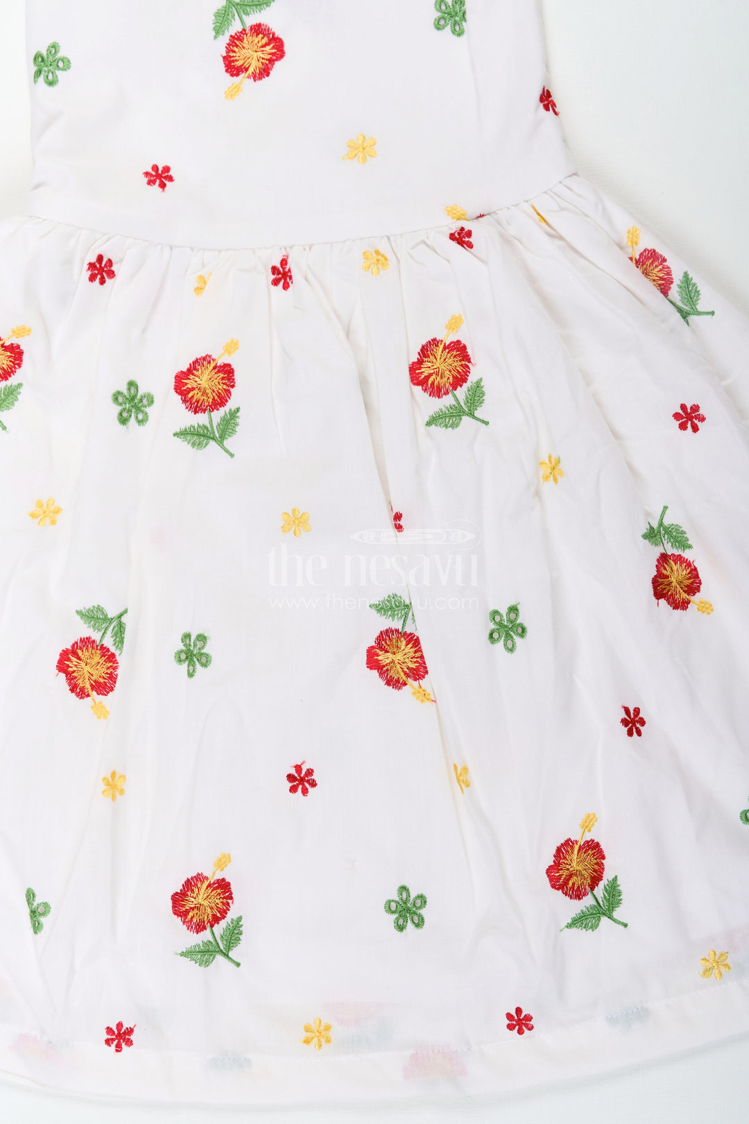 The Nesavu Girls Cotton Frock Girls White Floral Frock in Cotton Embroidery with Delicate Ruffles and Playful Design Nesavu Girls White Floral Frock Cotton Embroidery Ruffled Sleeves Flared Skirt | The Nesavu