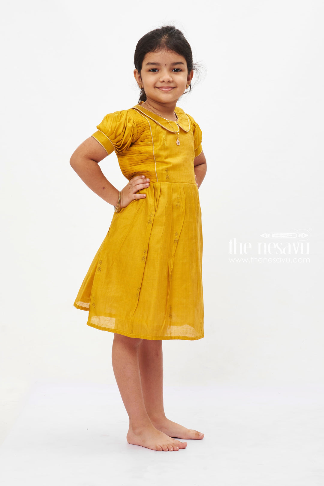 The Nesavu Girls Cotton Frock Golden Sunshine Puff Sleeve Dress: Girls' Mustard Yellow Frock with Shimmer Accents Nesavu Vibrant Mustard Yellow Girls Dress with Puff Sleeves | Shimmering Party Frock | The Nesavu