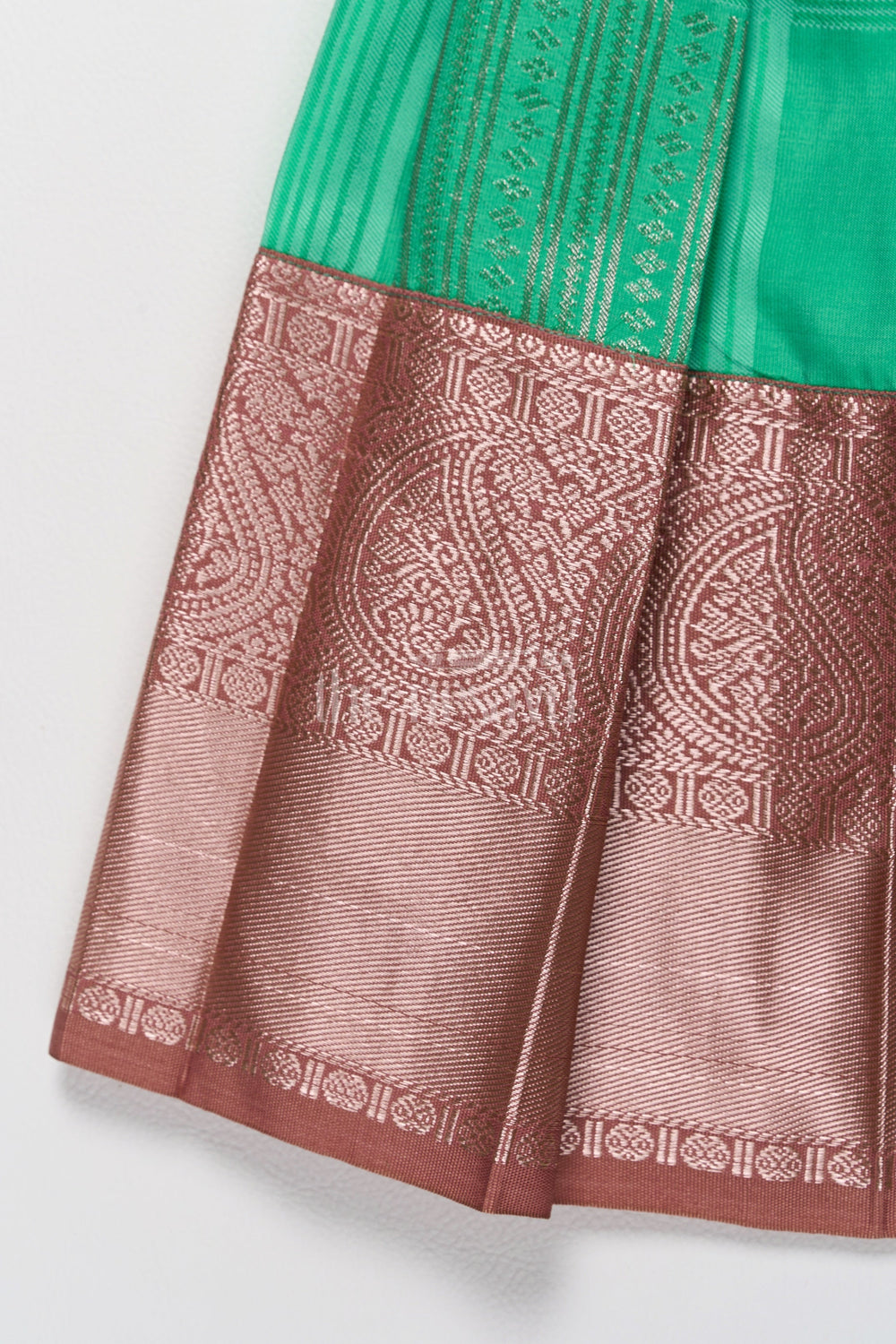 The Nesavu Girls Kanchi Silk Frock Green and Bronze Pattu Pavadai Frock Model for Girls with Golden Lace Nesavu Nesavus Green Bronze Pattu Pavadai Frock Model Girls Elegant Cape Design