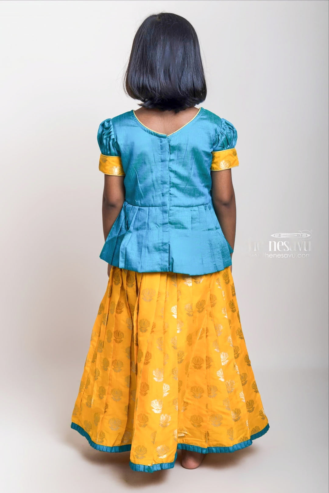 Green Pleated Peplum Blouse And Brocade Printed Yellow Silk Skirt For Girls