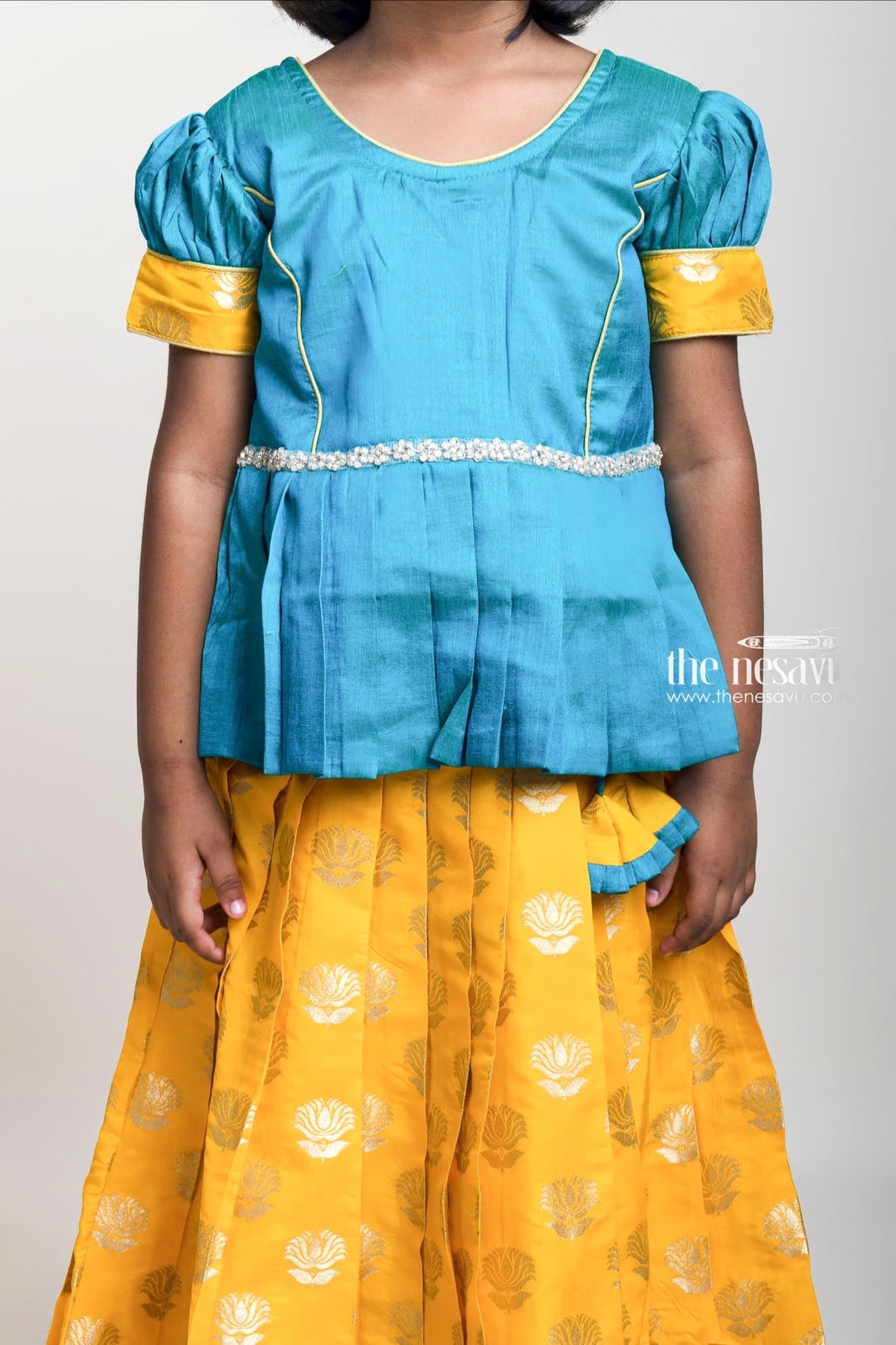 Green Pleated Peplum Blouse And Brocade Printed Yellow Silk Skirt For Girls