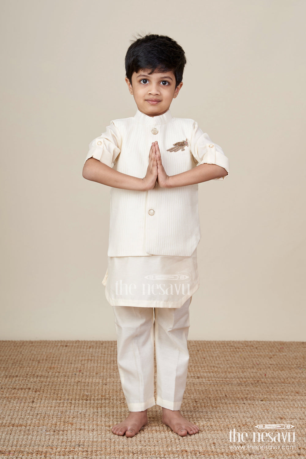 The Nesavu Boys Kurtha Set Ivory Kurta Set for Boys in Silk Blend with Designer Brooch Embellishment and Straight-Cut Pants Nesavu Ivory Kurta Set for Boys in Silk Blend with Brooch Embellishment and Stylish Jacket Design | The Nesavu