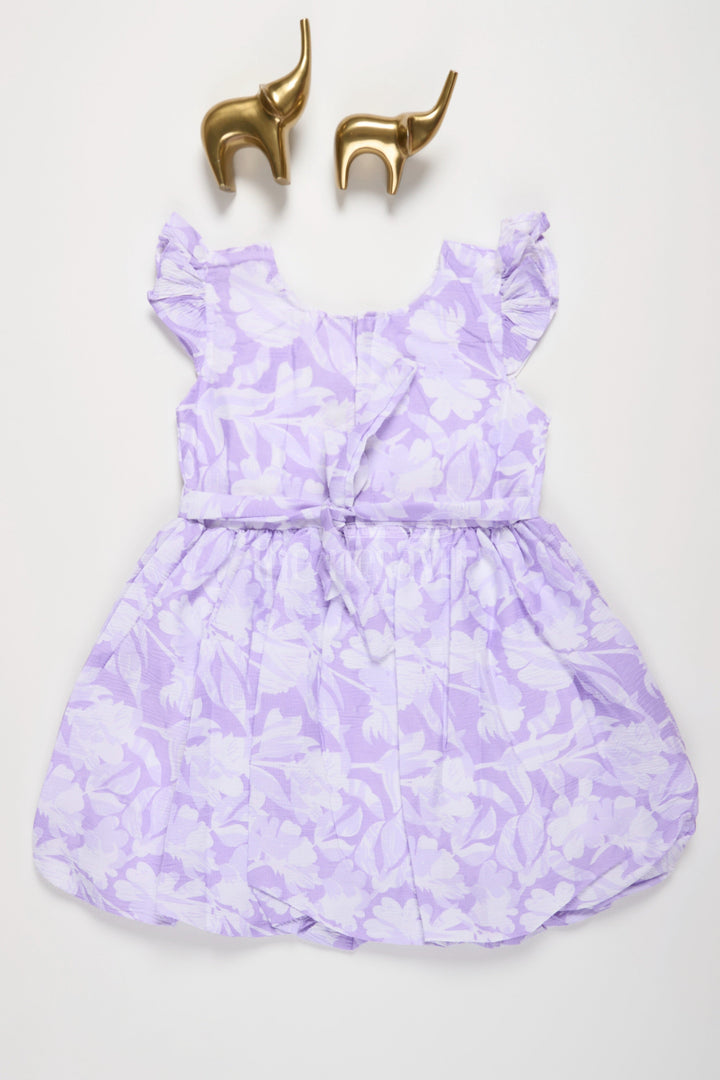 The Nesavu Girls Fancy Frock Lavender Blended Cotton Girls Fancy Frock with Floral Print and Ruffle Sleeves Nesavu Nesavu Lavender Floral Girls Fancy Frock Ruffle Sleeves Outdoor Gatherings