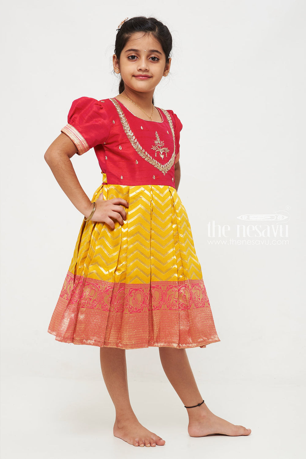 The Nesavu Silk Party Frock Majestic Maroon and Yellow Pattu Silk Frock: Intricate Gold Embroidery with Chevron for Girls Nesavu Maroon and Yellow Pattu Silk Frock | Chevron Pattern & Banarasi Border | Traditional Festive Wear for Girls | The Nesavu