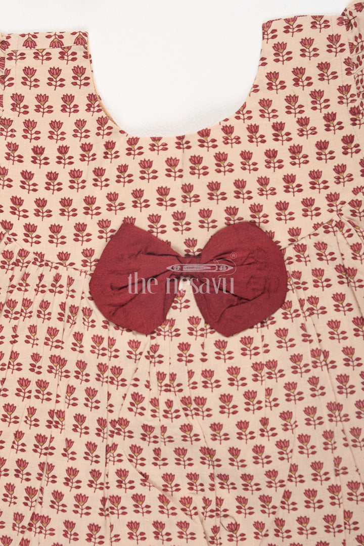 The Nesavu Baby Cotton Frocks Maroon Cotton Baby Frock with Mughal Lotus Motifs and Waist Bow Nesavu Maroon Cotton Baby Frock with Mughal Lotus Motifs and Waist Bow Nesavu