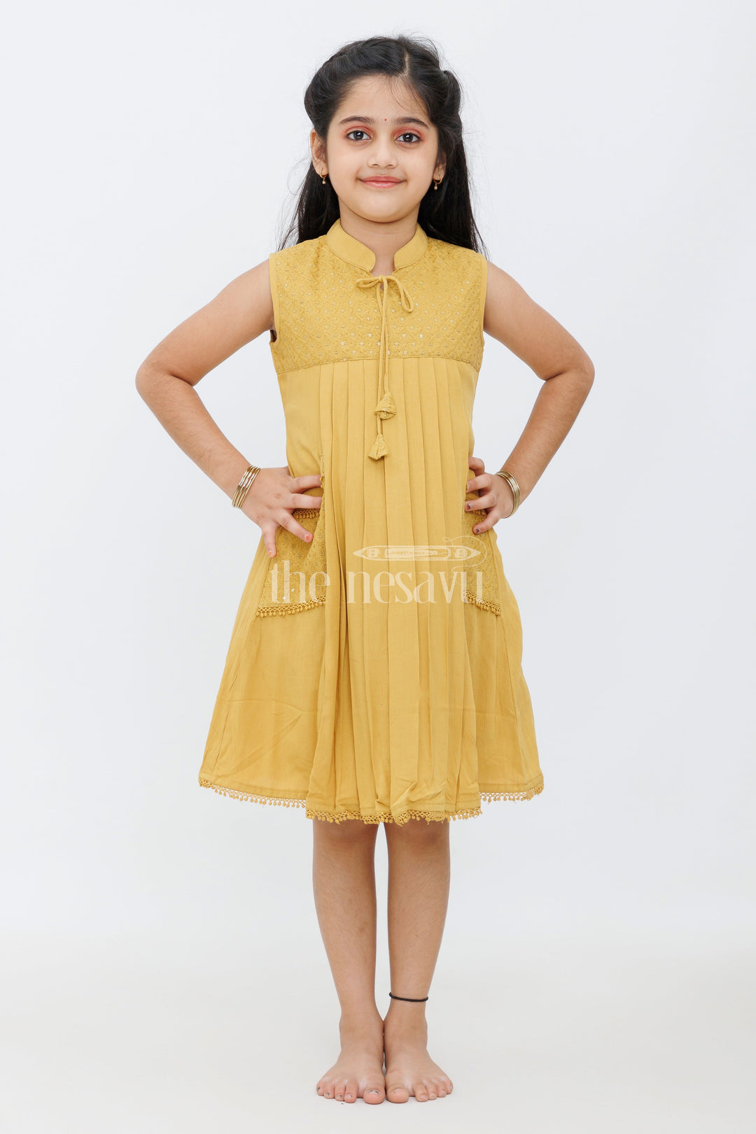 The Nesavu Girls Cotton Frock Mustard Cotton Frock with Center Box Pleats and Embroidered Yoke Line for Girls Nesavu Mustard Cotton Frock with Embroidered Yoke Line and Pleats for Girls Nesavu