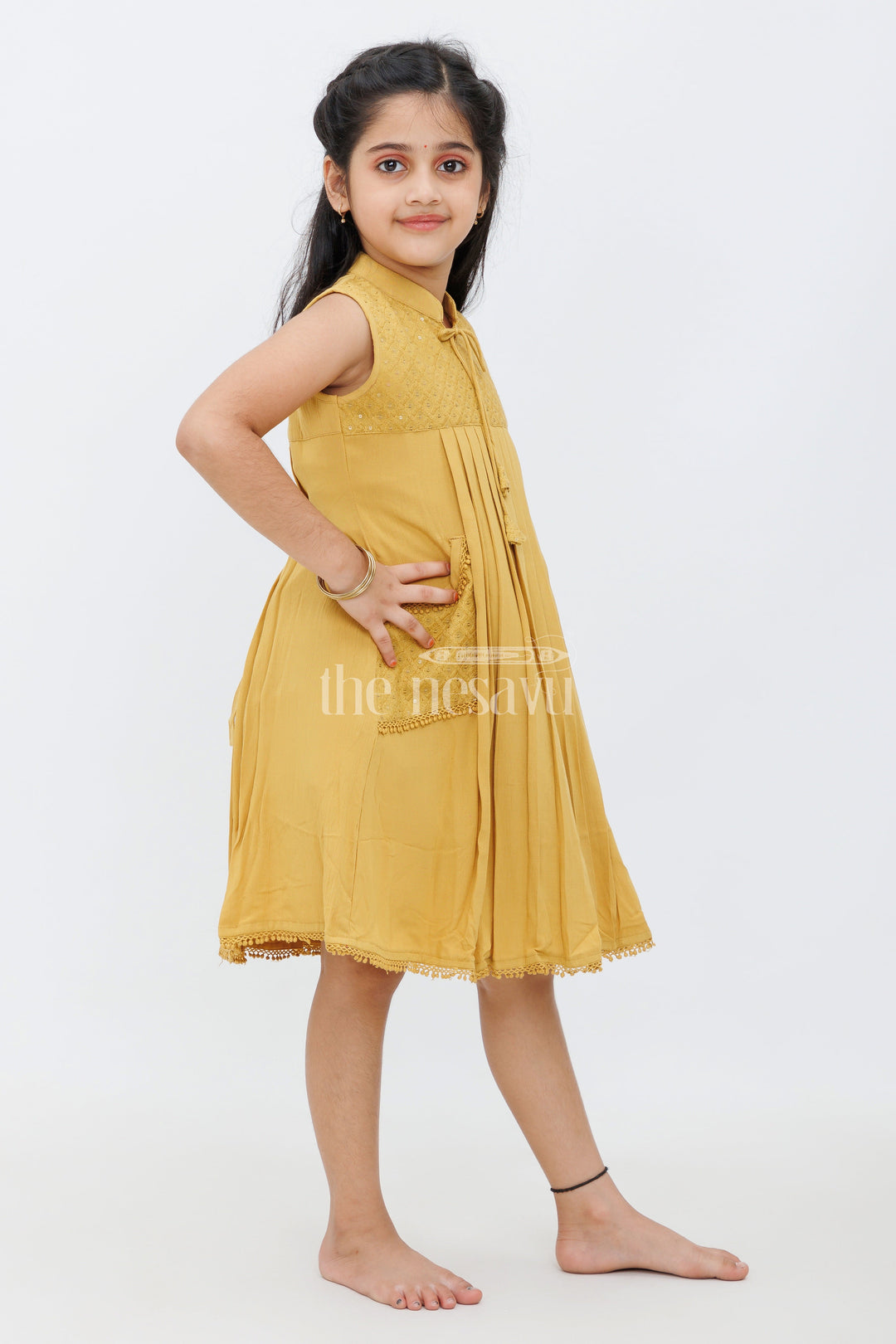 The Nesavu Girls Cotton Frock Mustard Cotton Frock with Center Box Pleats and Embroidered Yoke Line for Girls Nesavu Mustard Cotton Frock with Embroidered Yoke Line and Pleats for Girls Nesavu