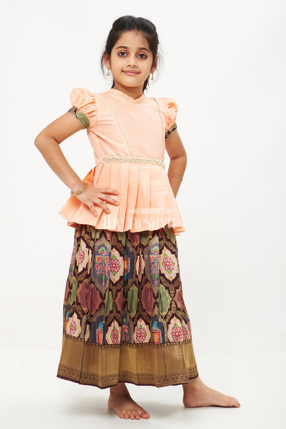 The Nesavu Pattu Pavadai Peach and Green Viscose Silk Peplum Top with Placement Print Skirt for Girls Nesavu