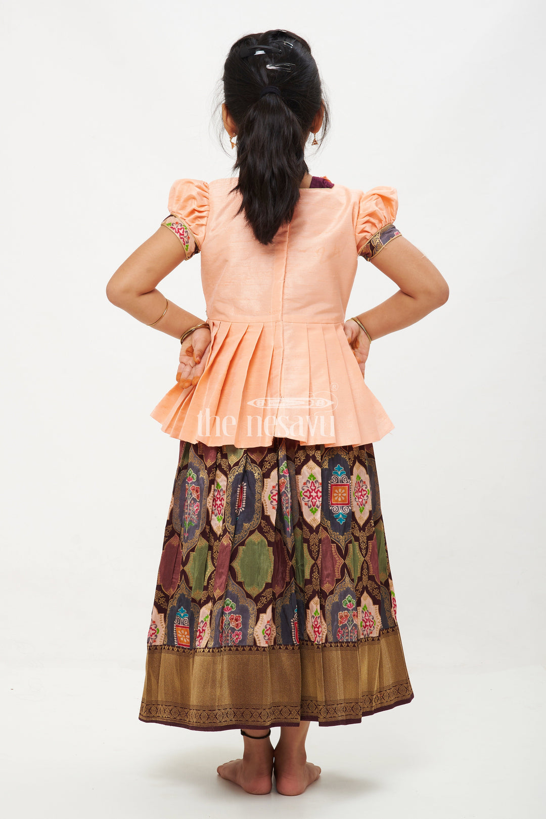 The Nesavu Pattu Pavadai Peach and Green Viscose Silk Peplum Top with Placement Print Skirt for Girls Nesavu