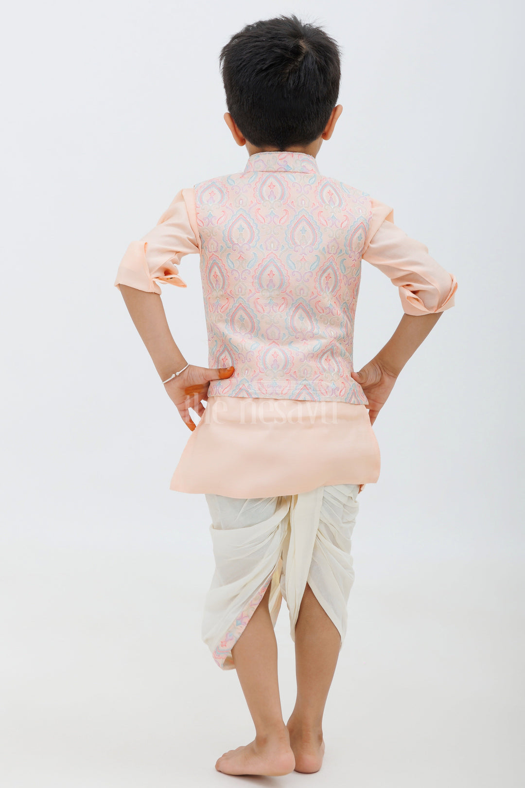 The Nesavu Boys Dothi Set Peach Color Designer Dhoti Kurta Set for Boys with Embroidered Jacket and Panchakacham Pants Nesavu Peach Color Designer Dhoti Kurta Set for Boys with Embroidered Jacket Nesavu