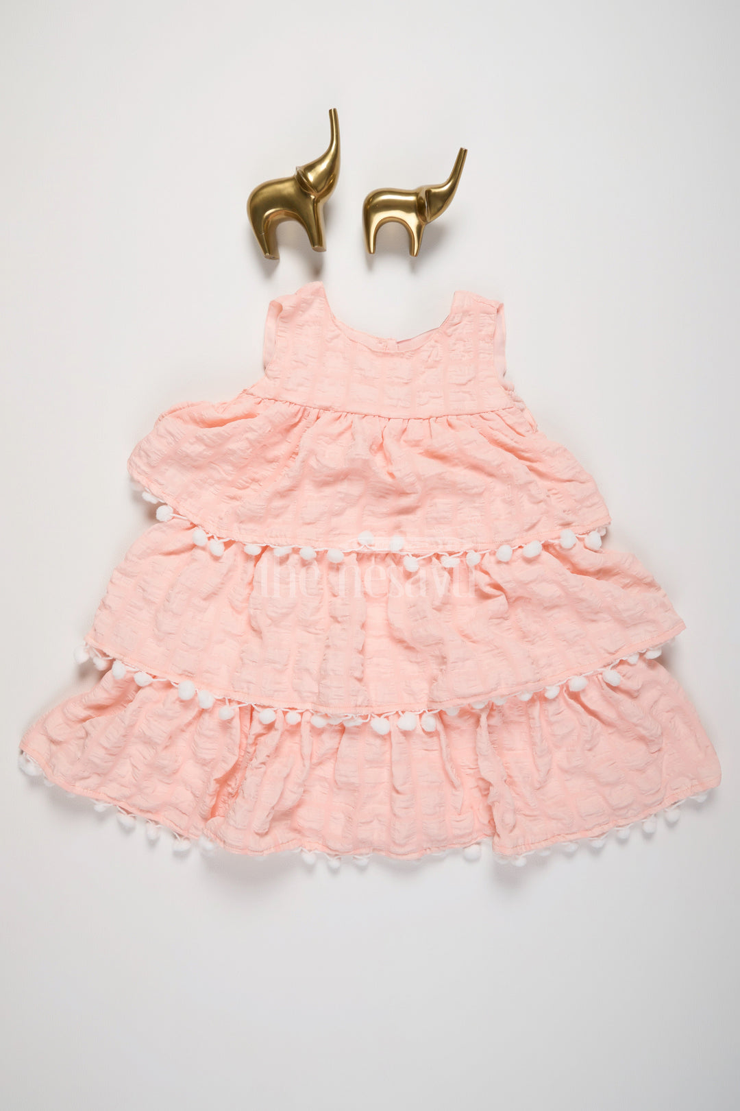 The Nesavu Girls Fancy Frock Peach-Tiered Girls Fancy Frock with White Pom-Pom Trim and Textured Fabric Nesavu 16 (1Y) / Peach BFJ657B-16 Nesavu Peach-Tiered Girls Fancy Frock White Pom-Pom Trim Textured Layers