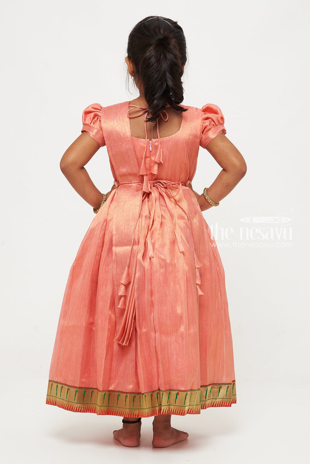 The Nesavu Girls Silk Gown Peach Tissue Fabric Saree Gown for Girls with Embroidered Hip Belt Nesavu