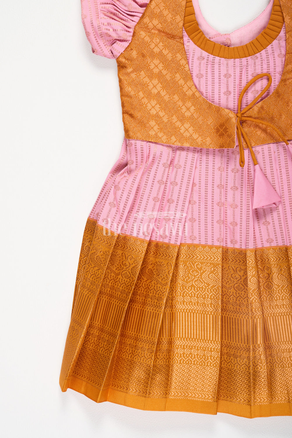 The Nesavu Girls Kanchi Silk Frock Pink and Gold Semi Kanchivaram Silk Frock with Puff Sleeves and Pleated Skirt for Girls Nesavu Nesavu Pink Gold Semi Kanchivaram Silk Frock Puff Sleeves Zari Detailing Festive Wear