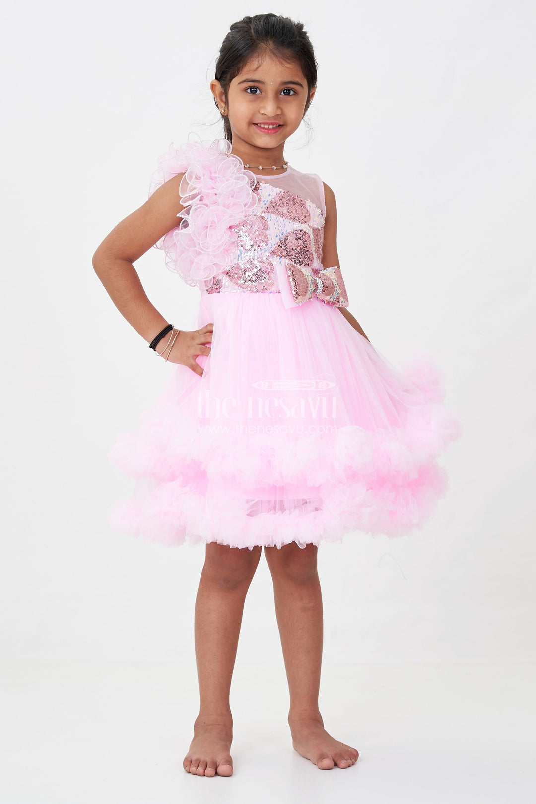 The Nesavu Girls Fancy Party Frock Pink Birthday Dress for Girls in Net with Ruffle Layers and Sequinned Yoke and Bow Nesavu Pink Birthday Dress Girls Net Sequin Yoke Layered Ruffle Skirt | The Nesavu