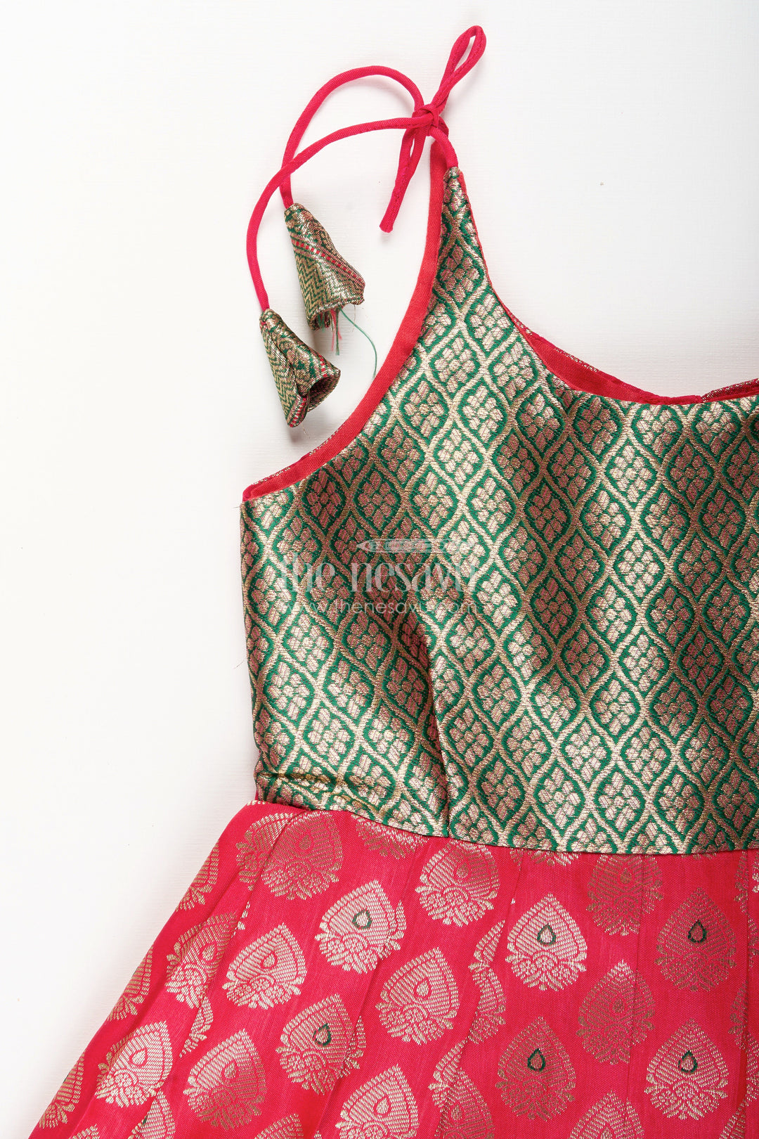 The Nesavu Tie-up Frock Semi Banaras Silk Tie-Up Frock for Baby Girl Green and Red Ethnic Dress Nesavu Nesavu semi Banaras silk frock for baby girl – red and green ethnic tie-up dress for celebrations