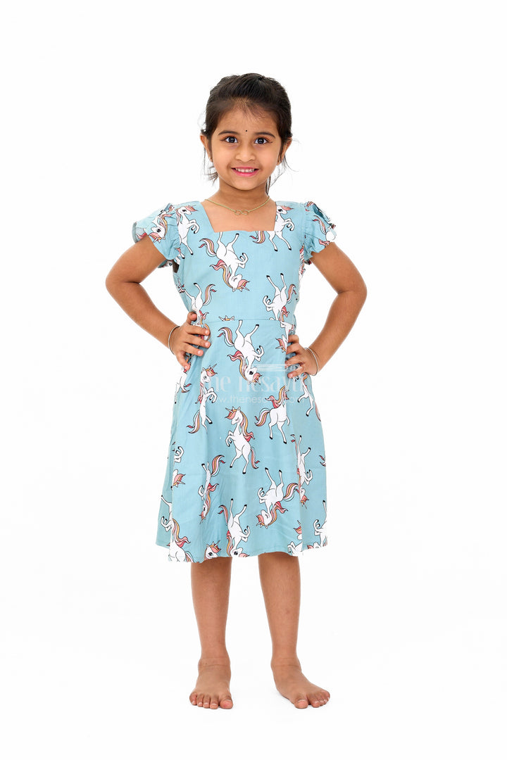 The Nesavu Girls Cotton Frock Stylish Girls Cotton Straight Dress with Unicorn Print and Ruffled Sleeves Nesavu 16 (1Y) / Teal GFC1557A-16 Girls Cotton Straight Dress Unicorn Print Ruffled Sleeves Teal Finish | The Nesavu