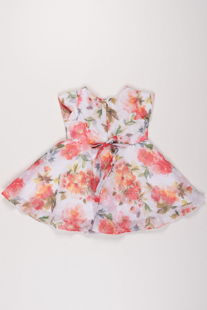 The Nesavu Girls Fancy Frock Summer Bloom Elegance Dress: Vibrant Floral Printed Frock for Girls with Bow Accent Nesavu Girls Floral Summer Dress | White Frock with Vivid Flowers | Playful Bow Detail | The Nesavu