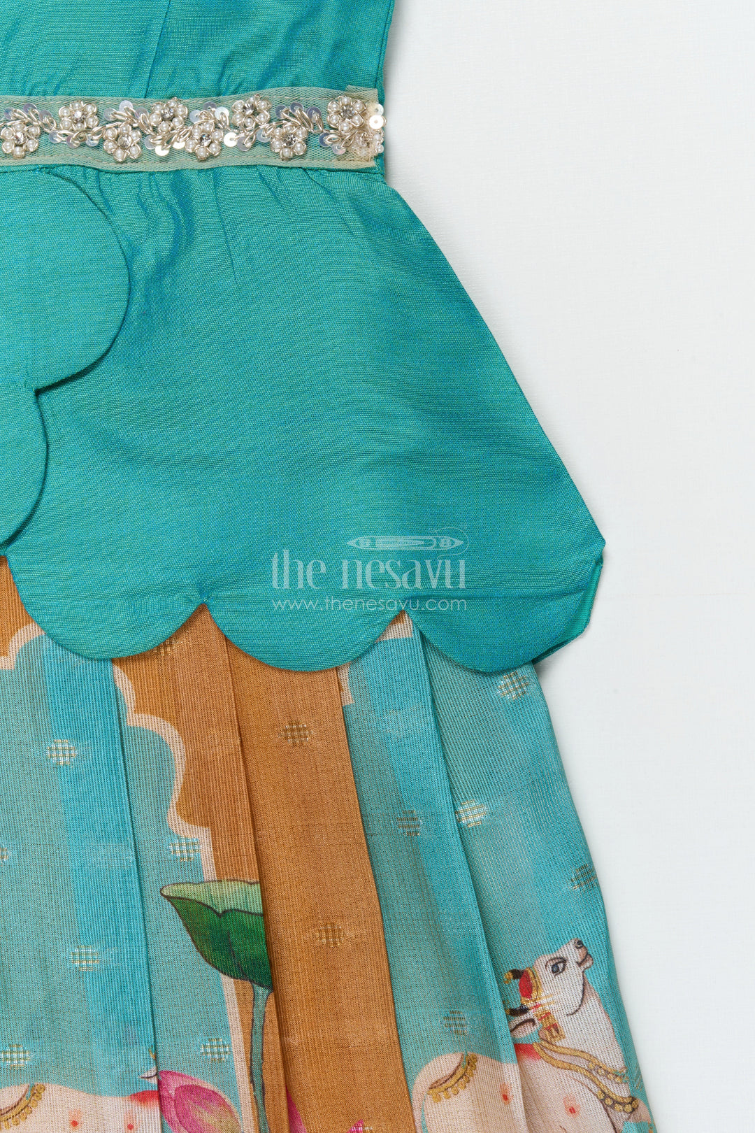 The Nesavu Pattu Pavadai Traditional Baby Pattu Pavadai with Lotus Print Skirt for Festive Photoshoots Nesavu Nesavu baby pattu pavadai with lotus print skirt and scallop blouse for festive occasions