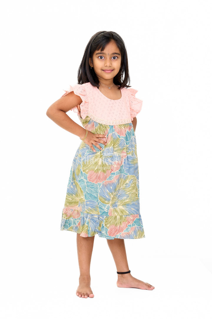 The Nesavu Girls Cotton Frock Trendy Girls Cotton New Dress with Vibrant Leaf Print and Lace Yoke Nesavu Girls Cotton New Dress Bold Leaf Print Flutter Sleeves Lace Detailing | The Nesavu