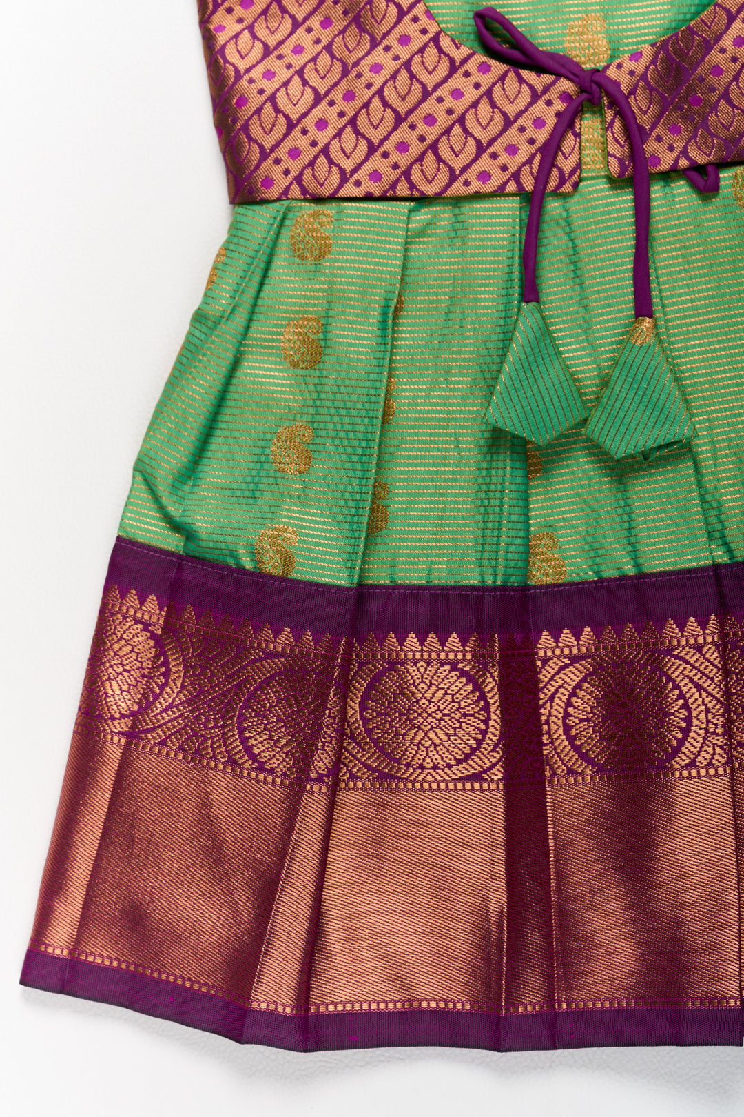 The Nesavu Girls Kanchi Silk Frock Vibrant Girls Kanchi Silk Frock in Green with Traditional Purple Borders for Pongal Fashion Nesavu Green Purple Girls Kanchi Silk Frock Pongal Nesavu