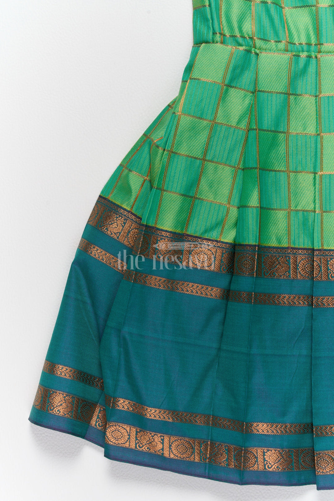 The Nesavu Girls Kanchi Silk Frock Vibrant Green Pattu Long Frock for Girls with Golden Checkered Pattern and Ruffled Yoke Nesavu Nesavus Green Pattu Long Frock Girls Golden Checkered Blend Silk Detailing