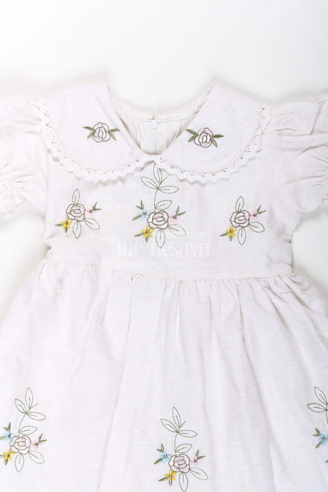 The Nesavu Girls Cotton Frock White Cotton Frocks for Girls with Floral Embroidery Puff Sleeves and Peter Pan Collar Nesavu White Cotton Frocks for Girls with Embroidery Puff Sleeves and Peter Pan Lace Collar | The Nesavu