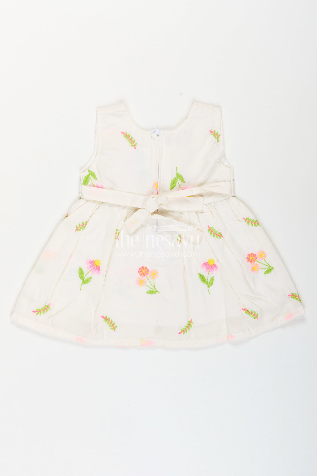 The Nesavu Baby Cotton Frocks White frock for baby girls with floral embroidery and waist bow Nesavu Nesavu white cotton frock for baby girls with bow and floral embroidery for casual dressing