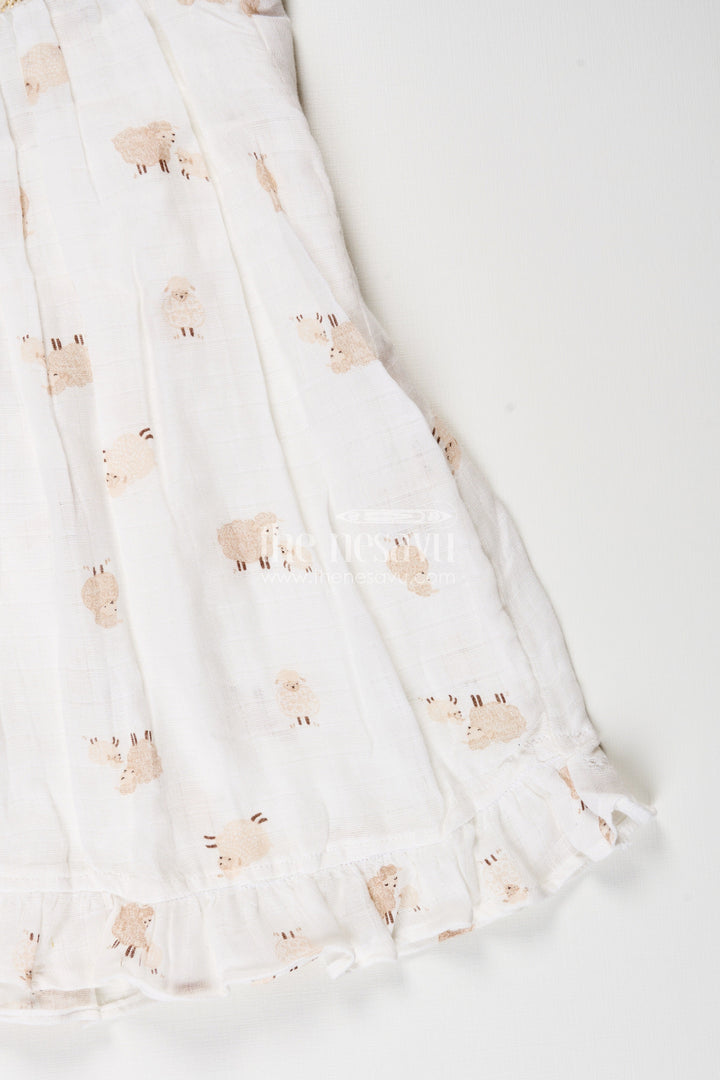 The Nesavu Girls Cotton Frock White Muslin Cotton Frock for Baby Girls with Soft Sheep Print Nesavu Nesavu baby girls white muslin cotton frock with sheep print and ruffle detailing for everyday wear