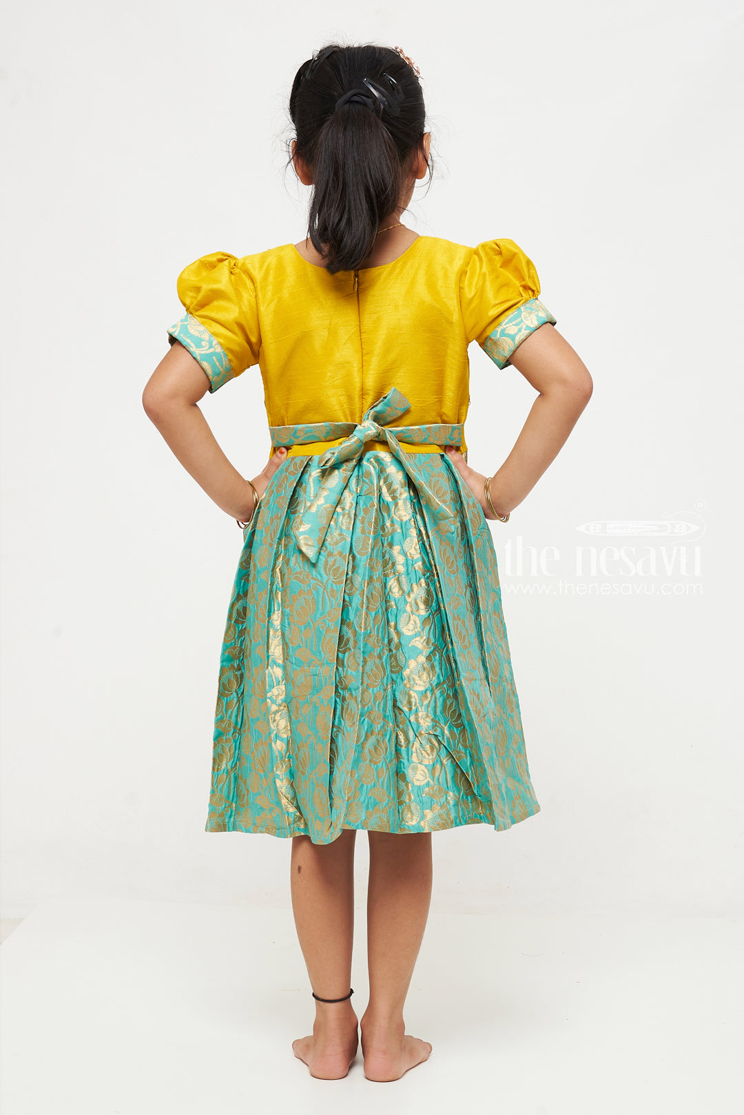 The Nesavu Silk Party Frock Yellow and Green Banarasi Semi-Silk Dress for Girls - Perfect for Navratri and Diwali Nesavu Yellow and Green Banarasi Semi-Silk Dress for Girls - Navratri and Diwali