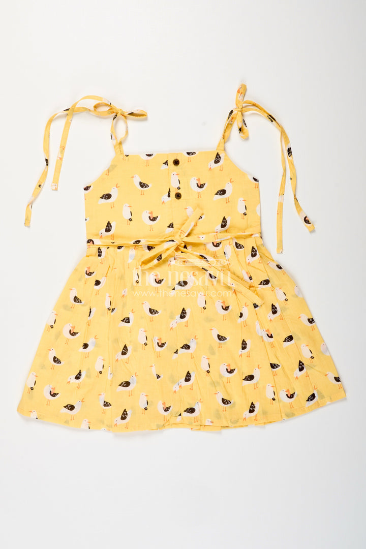 The Nesavu Tie-up Frock Yellow Tie-Up Cotton Frock for Toddler Girls with Playful Bird Print Nesavu Nesavu yellow cotton tie-up frock for toddler girls with playful bird print and pleated flare