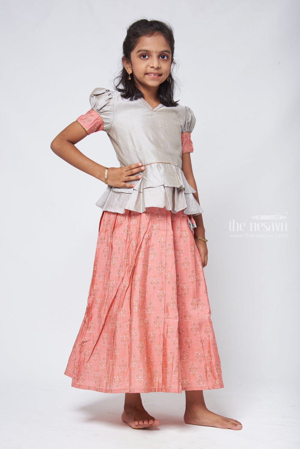 The Nesavu Pattu Pavadai Zari with Floral Printed Orange Pleated Skirt and Grey Jacquard Peplum Blouse Nesavu Latest Style Pattu Pavadai Design | Silk Readymade Dresses for Girls | The Nesavu